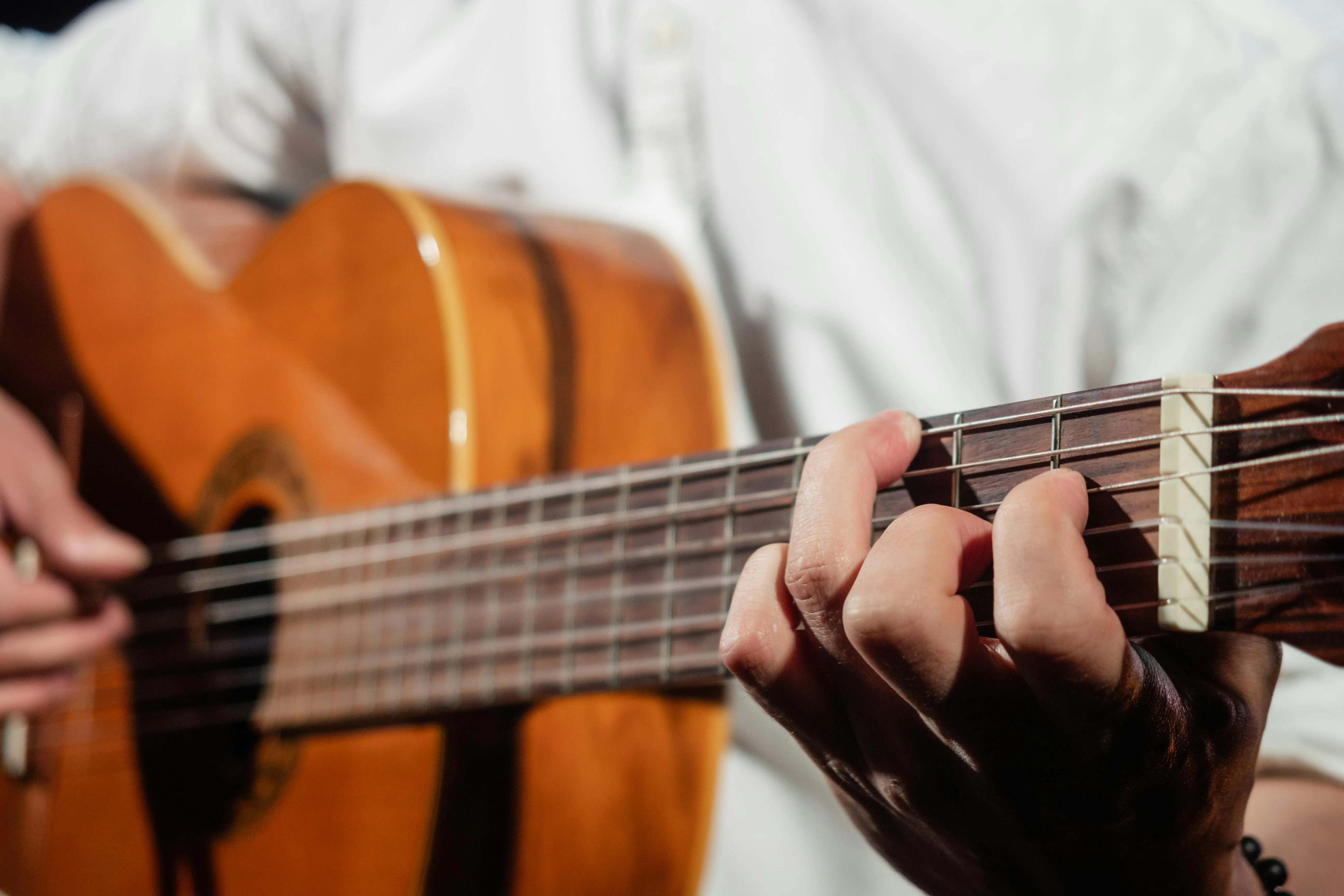Hand fretting a chord on a classical guitar